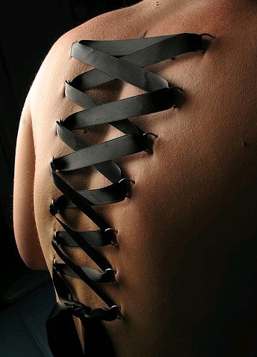 piercings on back. ack piercing corset. of these