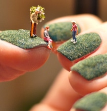 A World Of Miniature People Living On Green Fingernails
