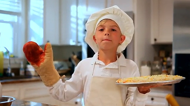 Kids Making Pizza In Kitchen